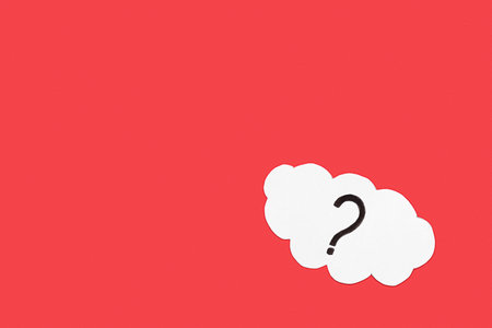 Paper cloud with question mark on red backgroundの写真素材
