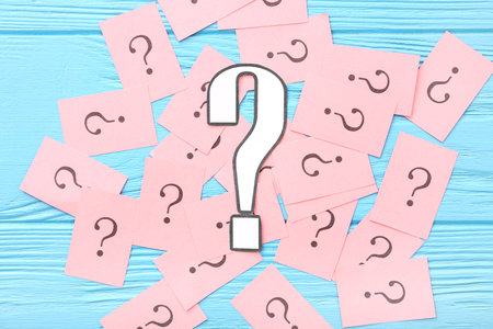 Papers with question marks on blue wooden backgroundの写真素材