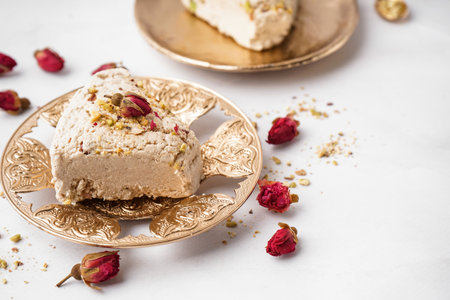 Plates with pieces of tasty Tahini halva on white backgroundの写真素材