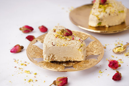 Plates with pieces of tasty Tahini halva on white backgroundの写真素材