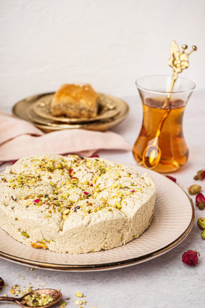 Plate of tasty Tahini halva with pistachios on light backgroundの写真素材