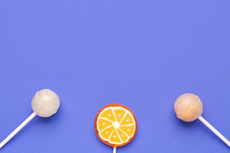 Sweet lollipops on blue backgroundの写真素材