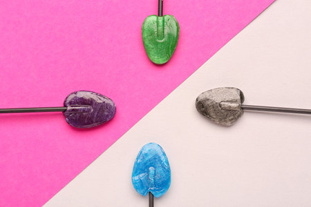 Sweet lollipops on pink and lilac backgroundの写真素材