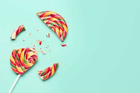 Crushed colorful lollipop on turquoise background