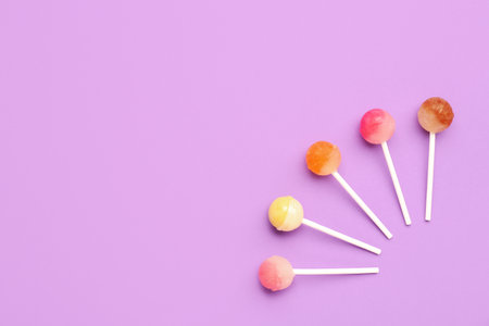 Composition with sweet lollipops on purple backgroundの写真素材