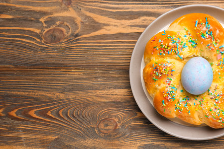 Tasty Italian Easter bread on dark wooden background