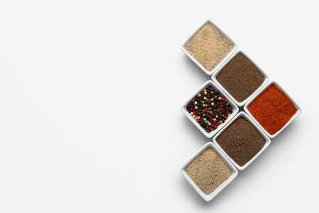 Composition with bowls of fresh aromatic spices on light background