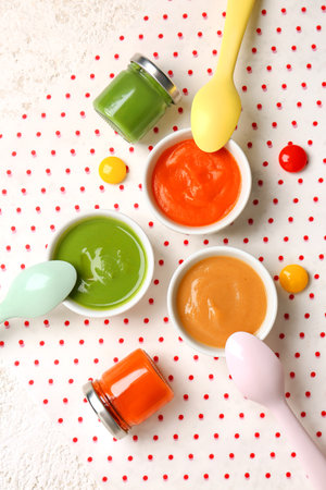 Bowls and jars of healthy baby food on tableの写真素材
