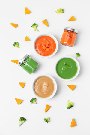 Composition with healthy baby puree and cut vegetables on white backgroundの写真素材