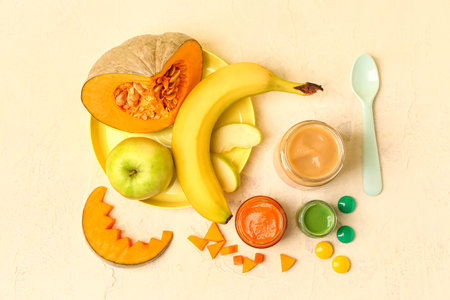 Composition with jars of healthy baby food, fresh fruits and vegetables on color backgroundの写真素材