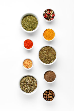 Composition with bowls of different aromatic spices on light backgroundの写真素材