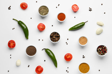 Composition with different spices and vegetables on light backgroundの写真素材