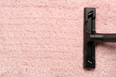Vacuum cleaner on pink carpetの写真素材