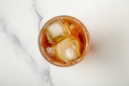 Glass of ice tea on white background