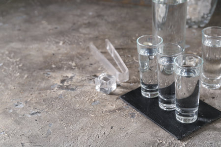 Glasses of vodka on gray backgroundの写真素材