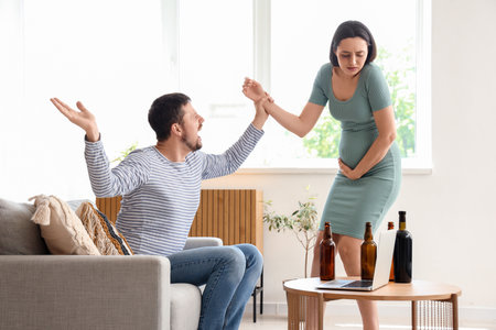 Drunk husband fighting with his pregnant wife at home. domestic violence conceptの写真素材