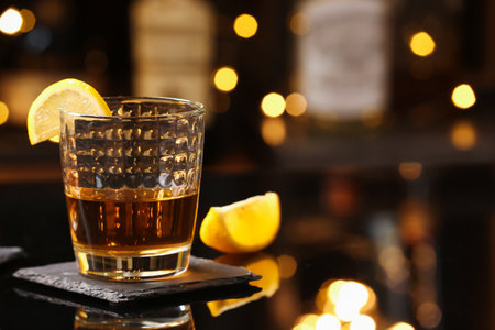 Glass of cold rum on table in barの写真素材