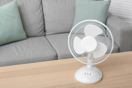 Modern electric fan on table in living roomの写真素材