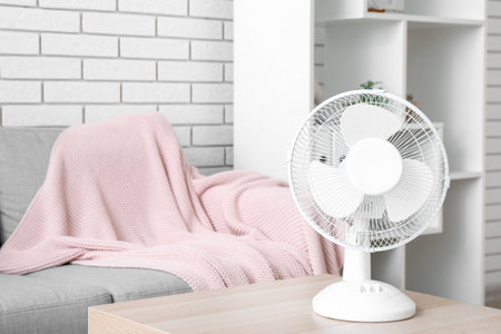 Modern electric fan on table in living roomの写真素材