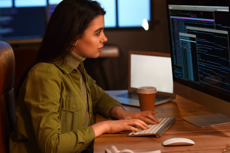 Young female programmer working in office