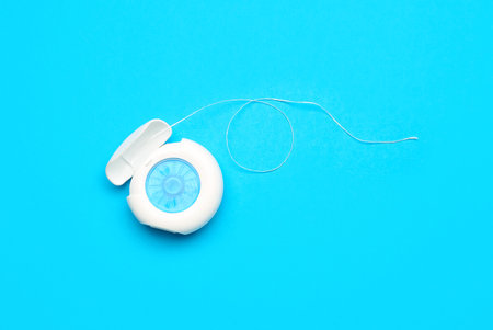 Case with dental floss on blue backgroundの写真素材