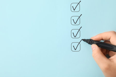 Woman marking on checklist box with black markerの写真素材