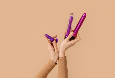 Woman with vibrators on beige backgroundの写真素材