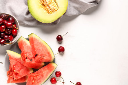 Bowl with pieces of fresh watermelon and different berries on white backgroundの写真素材
