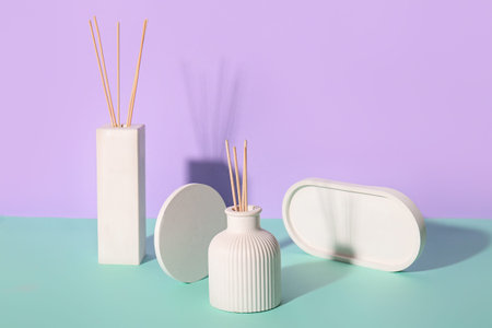 Bottles of reed diffuser on color background