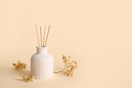 Floral reed diffuser and hydrangea flowers on beige backgroundの写真素材
