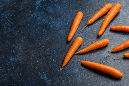 Many fresh carrots on blue backgroundの写真素材
