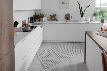 Stylish striped carpet in interior of modern kitchenの写真素材