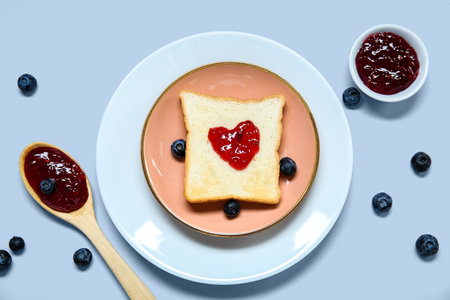 Composition with delicious toast, jam and blueberry on light backgroundの写真素材