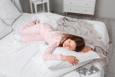 Morning of pretty young woman in bed