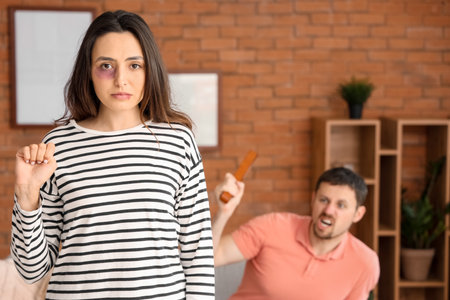 Bruised young woman gesturing at home. domestic violence conceptの写真素材