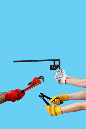 Female and male hands holding different construction tool on blue background