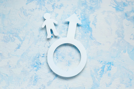 Male figure with man gender symbol on grunge blue backgroundの写真素材