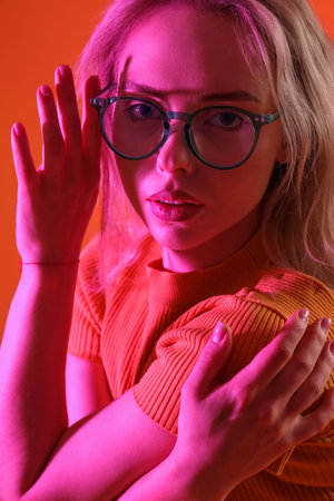 Young woman in stylish eyeglasses on color background, closeupの写真素材