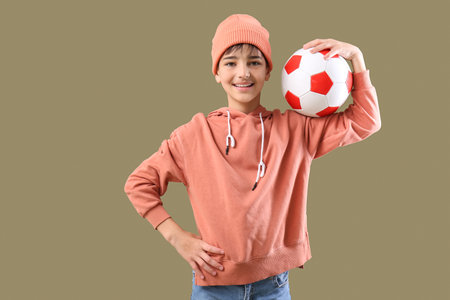Little boy with soccer ball on color backgroundの写真素材