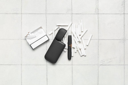 Modern electronic cigar, pack and sticks on white tiled backgroundの写真素材