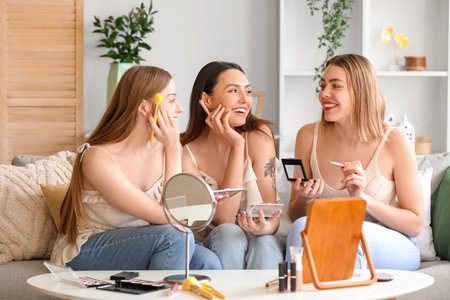 Young women doing makeup at homeの写真素材