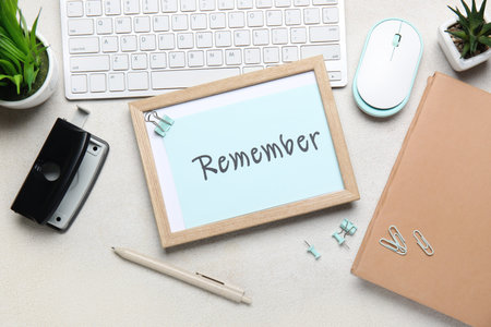 Reminder with stationery and computer keyboard on light background