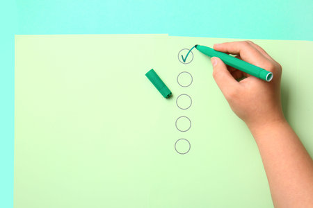 Woman marking on checklist box with green marker