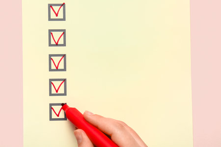 Woman marking on checklist box with red markerの写真素材