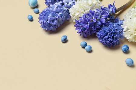 Beautiful hyacinth flowers and Easter eggs on beige backgroundの写真素材