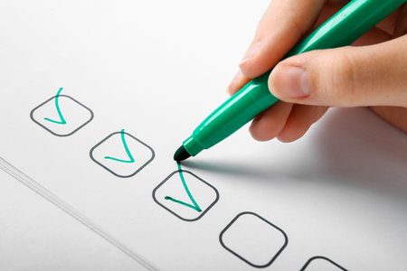 Woman marking on checklist box, closeupの写真素材