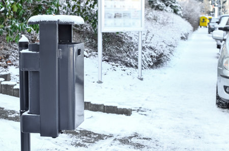 View of trash bin in city on winter dayの写真素材