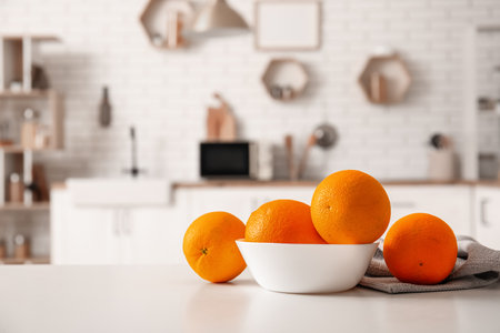 Bowl with oranges on table in interior of modern kitchenの写真素材