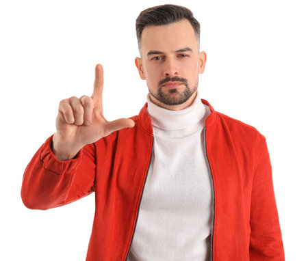 Handsome man showing loser gesture on white backgroundの写真素材