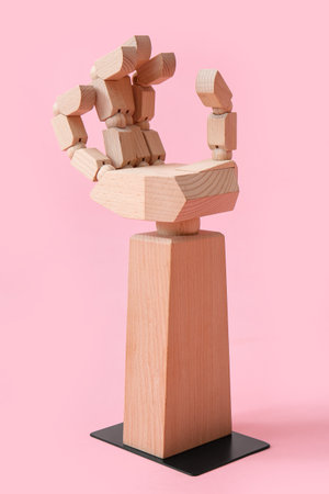 Decorative wooden hand on pink backgroundの写真素材